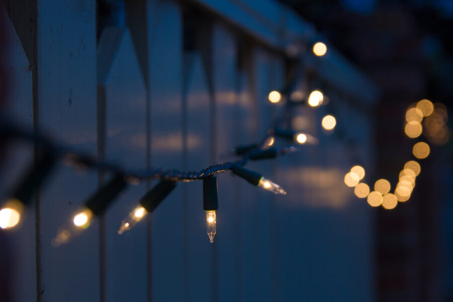 decorative outdoor christmas lights bluring into dark background ...